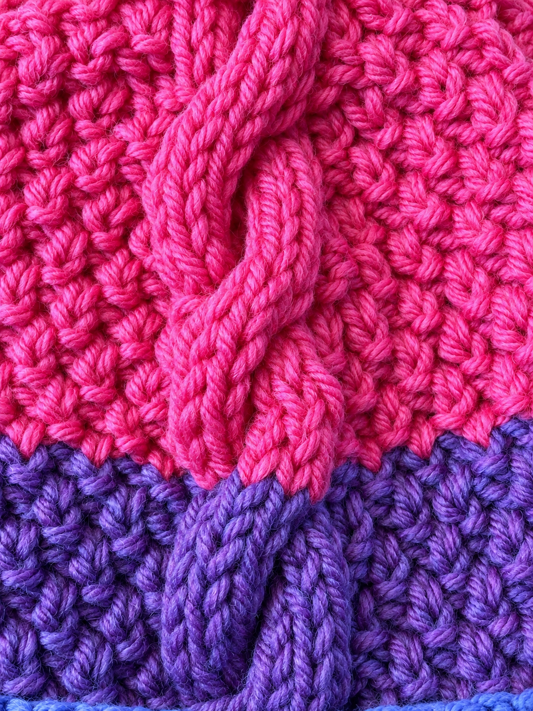 Berry Burst hand knitted cable beanie in pink purple and blue with pom pom